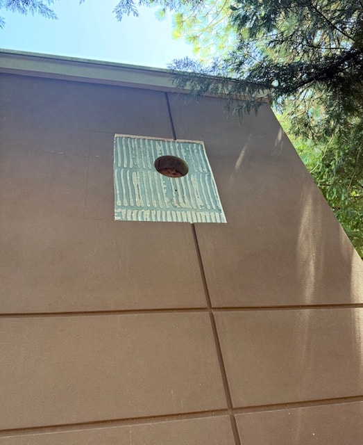 Ochre stucco storefront with decorative lattice pergola