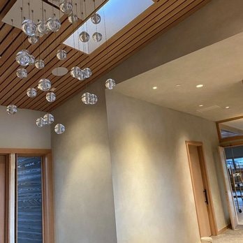 Luxury interior with decorative plaster walls and crystal pendant lighting