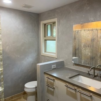 Bathroom with grey Venetian plaster walls, concrete countertop and custom vanity