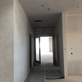 New construction hallway with smooth decorative plaster finish in progress