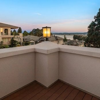 Smooth EIFS rooftop deck parapet walls with sunset view over the water