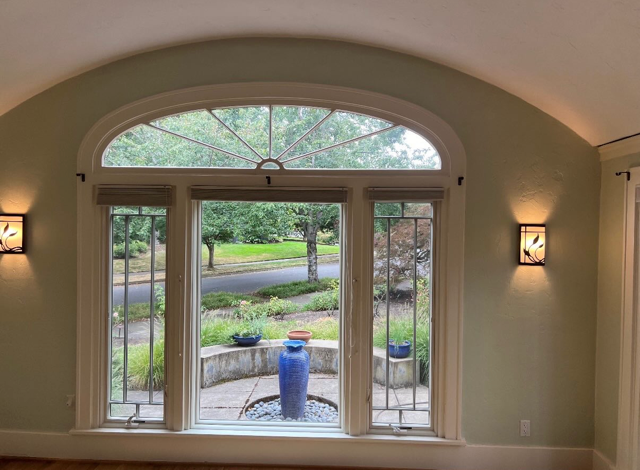 Restored foyer with arched transom window and plaster walls