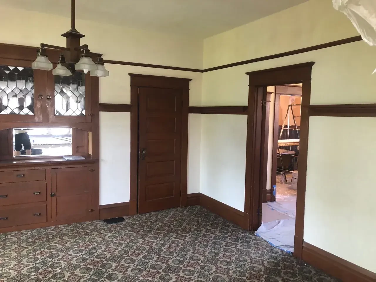 Craftsman-era room with restored plaster and dark wood trim