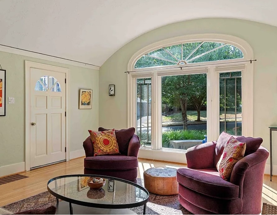 Restored historic living room with plaster walls and fireplace