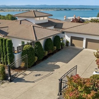 Mediterranean stucco estate with tile roof and water views