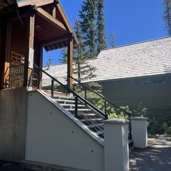 Mountain cabin with stucco stair walls and wood pergola exterior